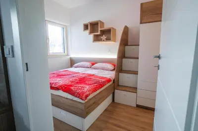 a bedroom with a bed in a small room at Vila Mojca Apartma Eva-Neža, Kranjska Gora (center) in Kranjska Gora