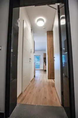 an empty hallway with a hallway leading to a room at Vila Mojca Apartma Eva-Neža, Kranjska Gora (center) in Kranjska Gora