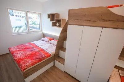 a small bedroom with a bed and a window at Vila Mojca Apartma Eva-Neža, Kranjska Gora (center) in Kranjska Gora