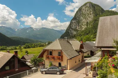 a row of houses with mountains in the background at Apartment house Jager in Bohinj
