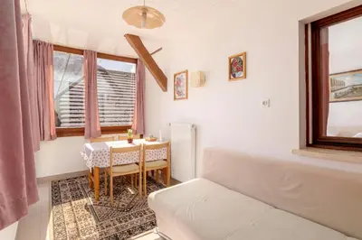 a small room with a table and a bed at Apartment house Jager in Bohinj