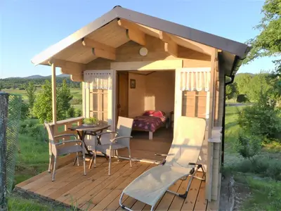 a gazebo with a table and chairs on a deck at Pension Na Meji in Pivka