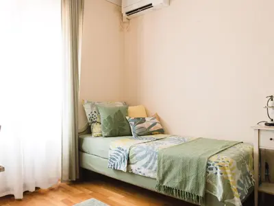 a bedroom with a bed and a window at Špacapanova hiša in Komen