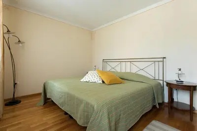 a bedroom with a bed with a yellow pillow on it at Špacapanova hiša in Komen