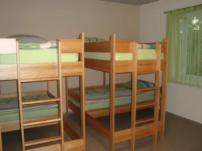 a room with three bunk beds in a room at Hostel Plus Caffe in Petrovče
