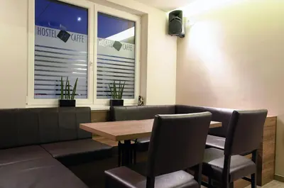 a dining room with a table and chairs and a window at Hostel Plus Caffe in Petrovče