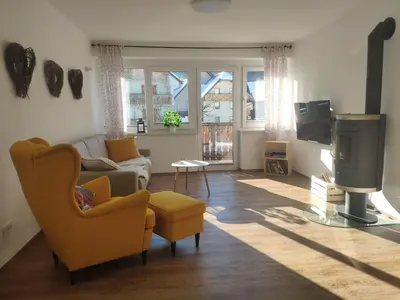 a living room with a couch and a tv at Cozy Nest in the heart of Kranjska Gora in Kranjska Gora