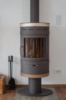 a woodburning stove in the corner of a room at Cozy Nest in the heart of Kranjska Gora in Kranjska Gora
