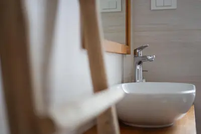 a bathroom with a white sink and a mirror at Cozy Nest in the heart of Kranjska Gora in Kranjska Gora