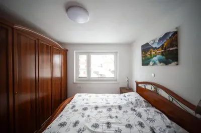 a bedroom with a bed and a window at Cozy Nest in the heart of Kranjska Gora in Kranjska Gora