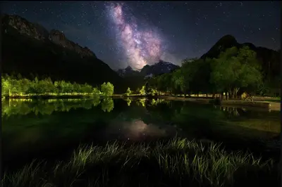 a starry night over a lake with the milky way at Cozy Nest in the heart of Kranjska Gora in Kranjska Gora