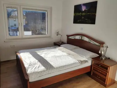 a bedroom with a bed and a window at Cozy Nest in the heart of Kranjska Gora in Kranjska Gora