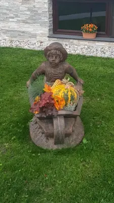 a statue of a girl with a basket of flowers at Apartma Sebastjan Dobova near Terme Paradiso in Dobova