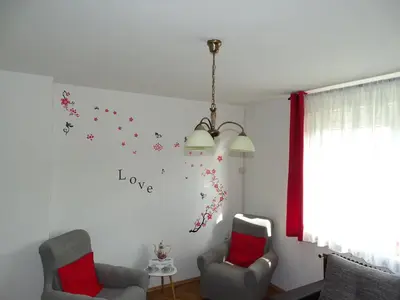 a living room with two chairs and stars on the wall at Apartma Sebastjan Dobova near Terme Paradiso in Dobova