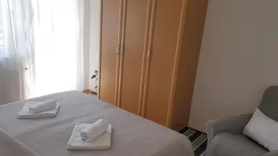 a bedroom with a bed and a chair and a cabinet at Apartma Sebastjan Dobova near Terme Paradiso in Dobova