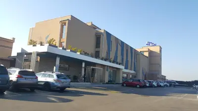 a parking lot with cars parked in front of a building at Apartma Sebastjan Dobova near Terme Paradiso in Dobova