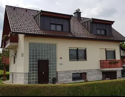a large white house with a black roof at Apartma Sebastjan Dobova near Terme Paradiso in Dobova