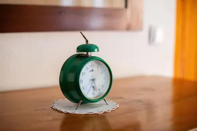 a green clock sitting on top of a table at House, Garden and a Green Cat in Bled