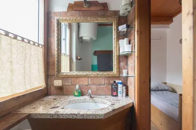 a bathroom with a sink and a mirror at Cozy, Bright and Affordable Single Studio - Free Parking in Ljubljana