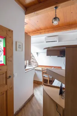 a kitchen with a table and a dining room at Cozy, Bright and Affordable Single Studio - Free Parking in Ljubljana
