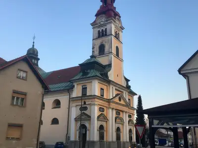 a large building with a clock tower on top at Cozy, Bright and Affordable Single Studio - Free Parking in Ljubljana