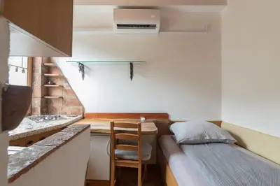 a small kitchen with a couch and a table in a room at Cozy, Bright and Affordable Single Studio - Free Parking in Ljubljana
