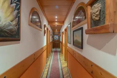 a corridor in a house with wooden walls and a hallway at Cozy, Bright and Affordable Single Studio - Free Parking in Ljubljana