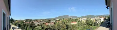 a view of a town with mountains in the background at Vila Burbonka in Nova Gorica