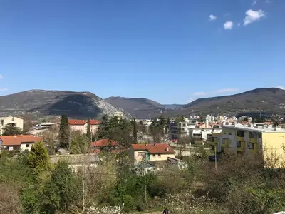a city with houses and mountains in the background at Vila Burbonka in Nova Gorica