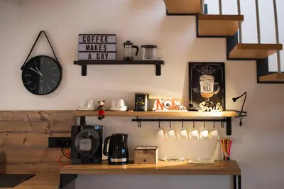 a coffee shop with a clock on the wall at Apartments Maison in Kranjska Gora