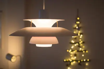a chandelier hanging in front of a christmas tree at Apartments Maison in Kranjska Gora