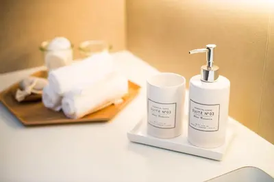 a bathroom with two bottles of soap and towels at Apartments Maison in Kranjska Gora