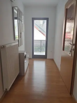 an empty hallway with a door and a wooden floor at Apartma Katja in Mojstrana