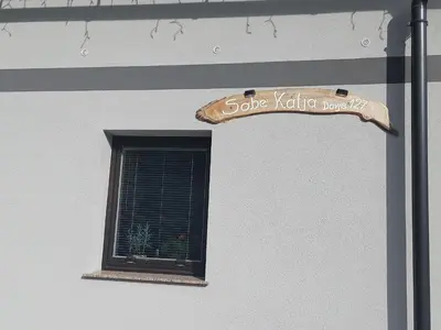a window with a sign on the side of a building at Apartma Katja in Mojstrana