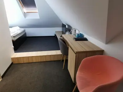 a small room with a desk and a bed at Cha Cha Rooms in Ljubljana