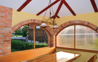 a kitchen with an arched window and a table at Three-Bedroom Holiday Home In Gradac in Gradac