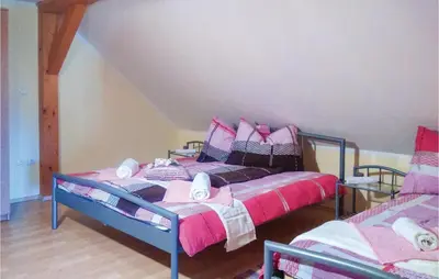 a bedroom with a bed with pink blankets and pillows at Three-Bedroom Holiday Home In Gradac in Gradac