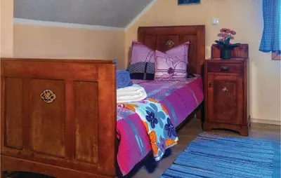 a bedroom with a bed and a dresser and a bed sidx sidx at Three-Bedroom Holiday Home In Gradac in Gradac