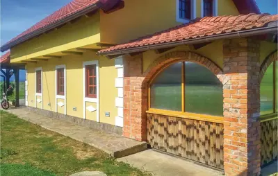 a small house with an archway on the side of it at Three-Bedroom Holiday Home In Gradac in Gradac