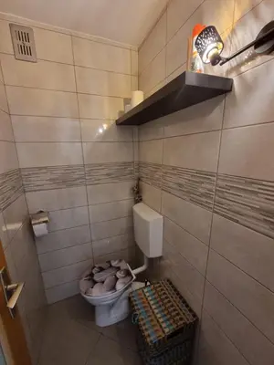 a small bathroom with a toilet and a basket at Apartment Gulek in Zreče