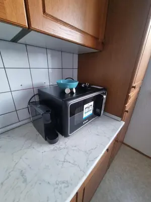 a microwave sitting on a counter in a kitchen at Apartment Gulek in Zreče