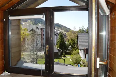an open window with a view of a house at Apartment Viki in Kranjska Gora