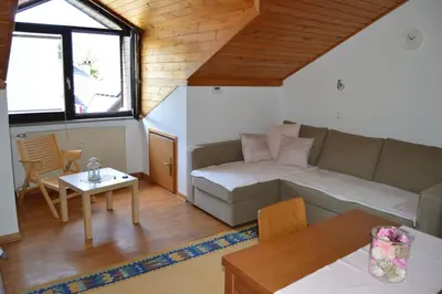 a living room with a couch and a table at Apartment Viki in Kranjska Gora