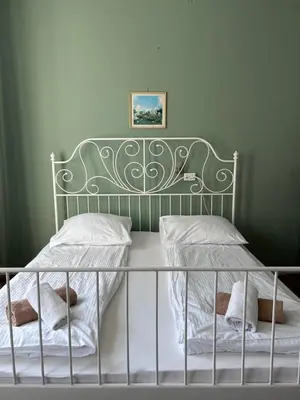 a bed with a metal headboard and two pillows at Vila Gorenka in Bled