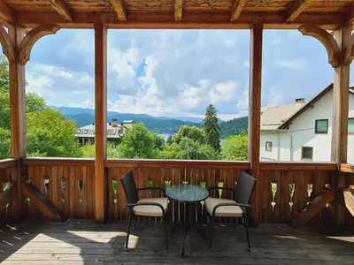 a patio with a table and chairs on a porch at Vila Gorenka in Bled