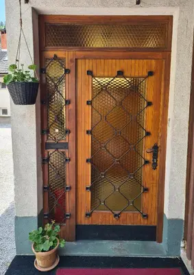 a wooden door with a wrought iron gate at Vila Gorenka in Bled