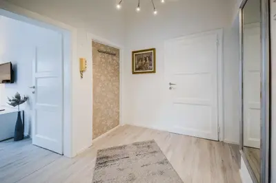 an empty room with two white doors and a rug at Kavon Apartments in Ljubljana