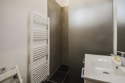 a bathroom with a white sink and a mirror at Kavon Apartments in Ljubljana