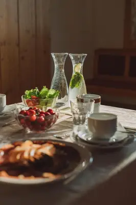 a table with a plate of food and bowls of food at Tourist Farm Pr'Dovar in Cerklje na Gorenjskem