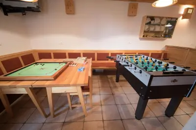 a room with a foosball table and a pool table at Tourist Farm Pr'Dovar in Cerklje na Gorenjskem